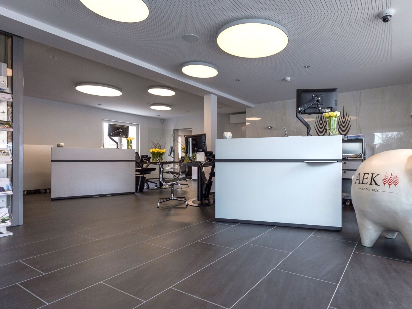 Kühlung Büroräume der AEK Bank in Thun. Im Hintergrund ist ein weisses Design Klimagerät von der Zaugg Kälte Klima AG zu sehen. Kühlung Büroräume der AEK Bank in Thun. Im Hintergrund ist ein weisses Design Klimagerät von der Zaugg Kälte Klima AG zu sehen.